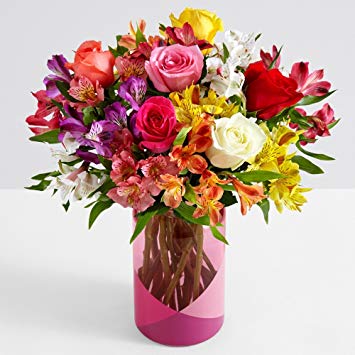 multi colored smiles and sunshine flowers with clear vase
